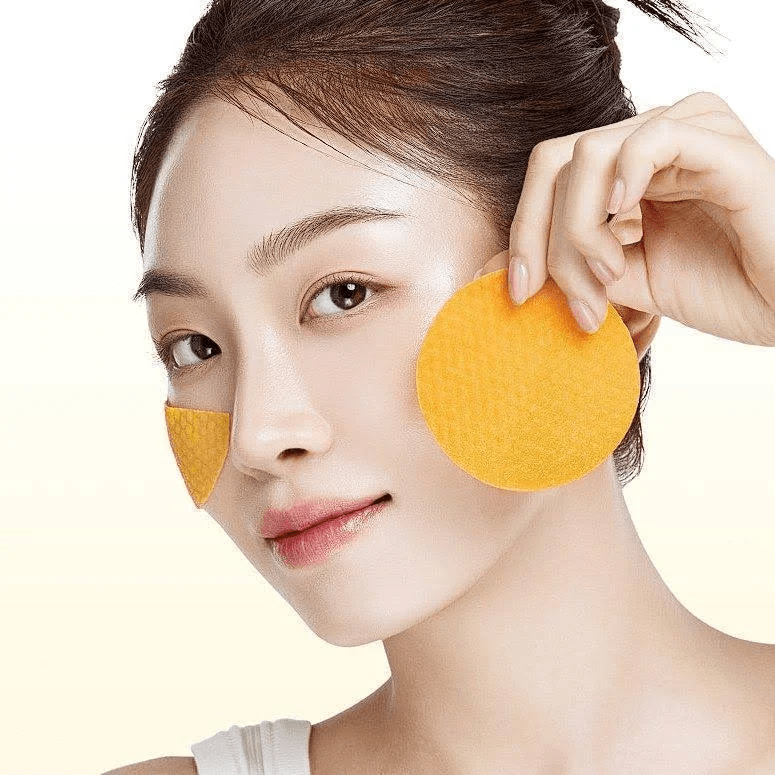 Anua Vitamin C Niacin toner pad applied to cheeks