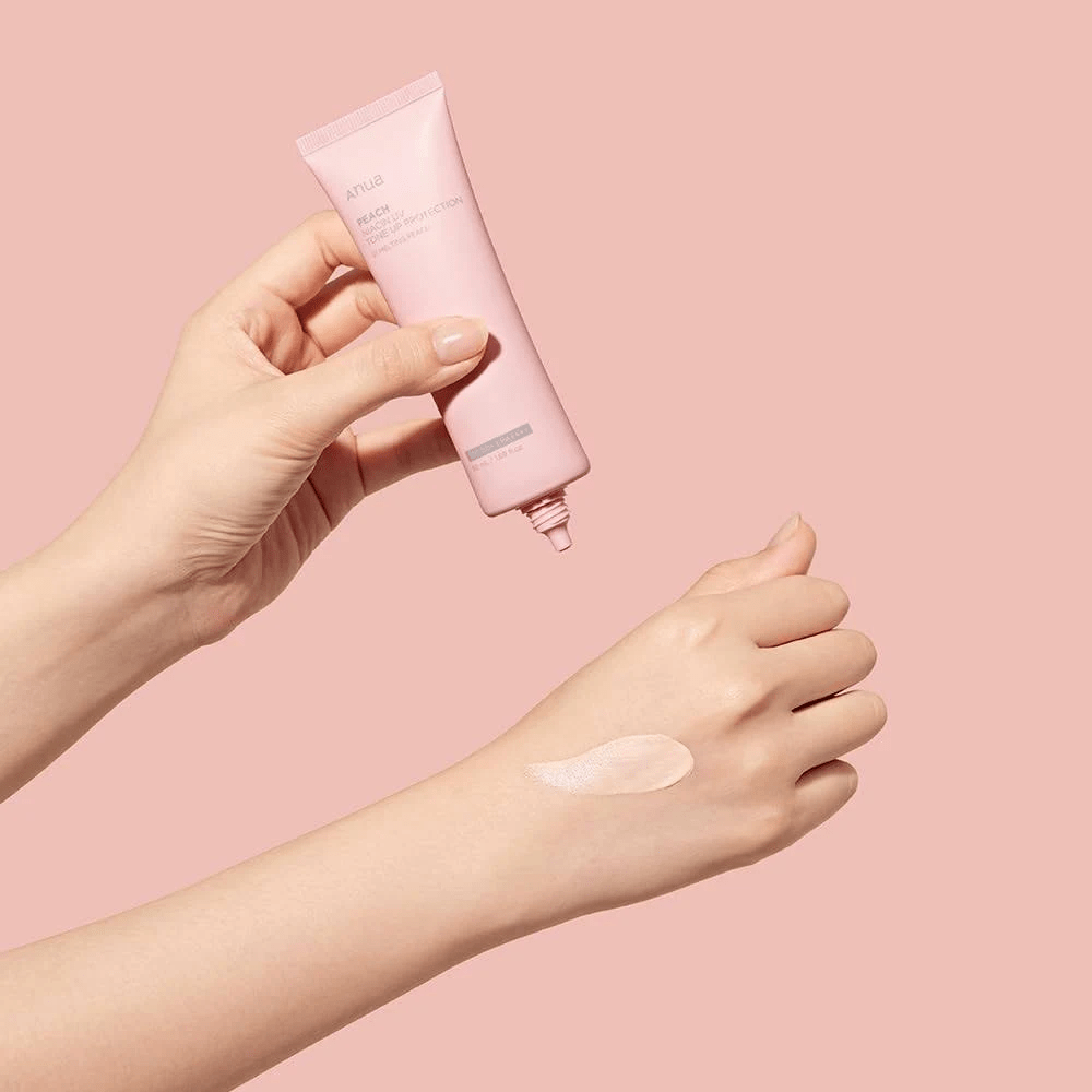 Anua Peach Niacin UV Tone Up Protection 01 Melting Peach 50ml applied on the back of a hand