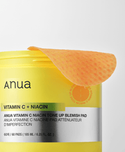 Official close-up of Anua Vitamin C Niacin pad and matching jar