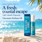 Beachy Bubbles Bath Co Oceanaire Perfume Oil and turquoise carton beside the ocean, highlighting its light aquatic fragrance.