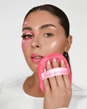 MakeUp Eraser Daily pink makeup remover pad in use on face
