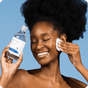 Model applying ROUND LAB Birch Juice Moisturizing Toner with a cotton pad