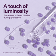 Close-up of SpaLife Repair serum with dissolving lavender pearlescent spheres and glass pipette